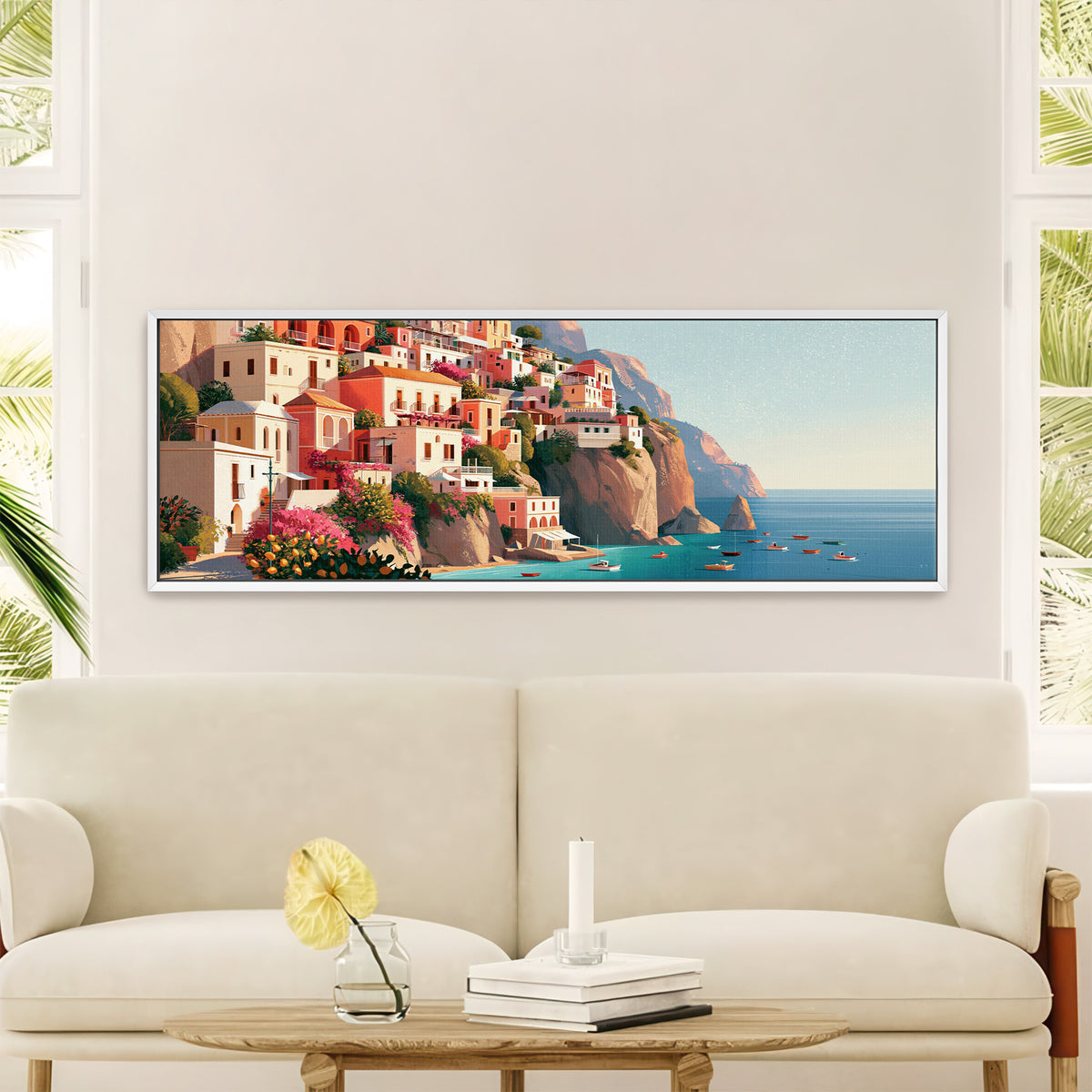 coral cliffside houses above turquoise water canvas wall art in a white floater frame in a styled room setting