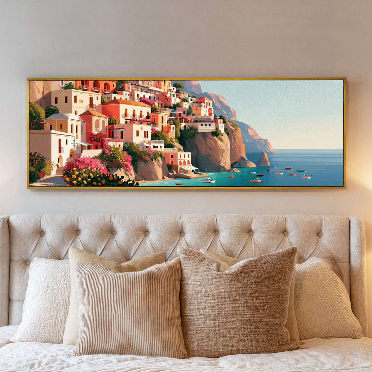 coral cliffside houses above turquoise water canvas wall art in a gold floater frame above a bed