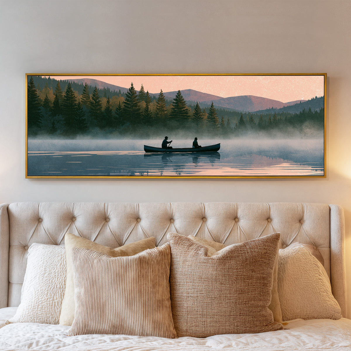 two canoeists on a misty forest lake beneath a canvas wall art in a gold floater frame above a bed