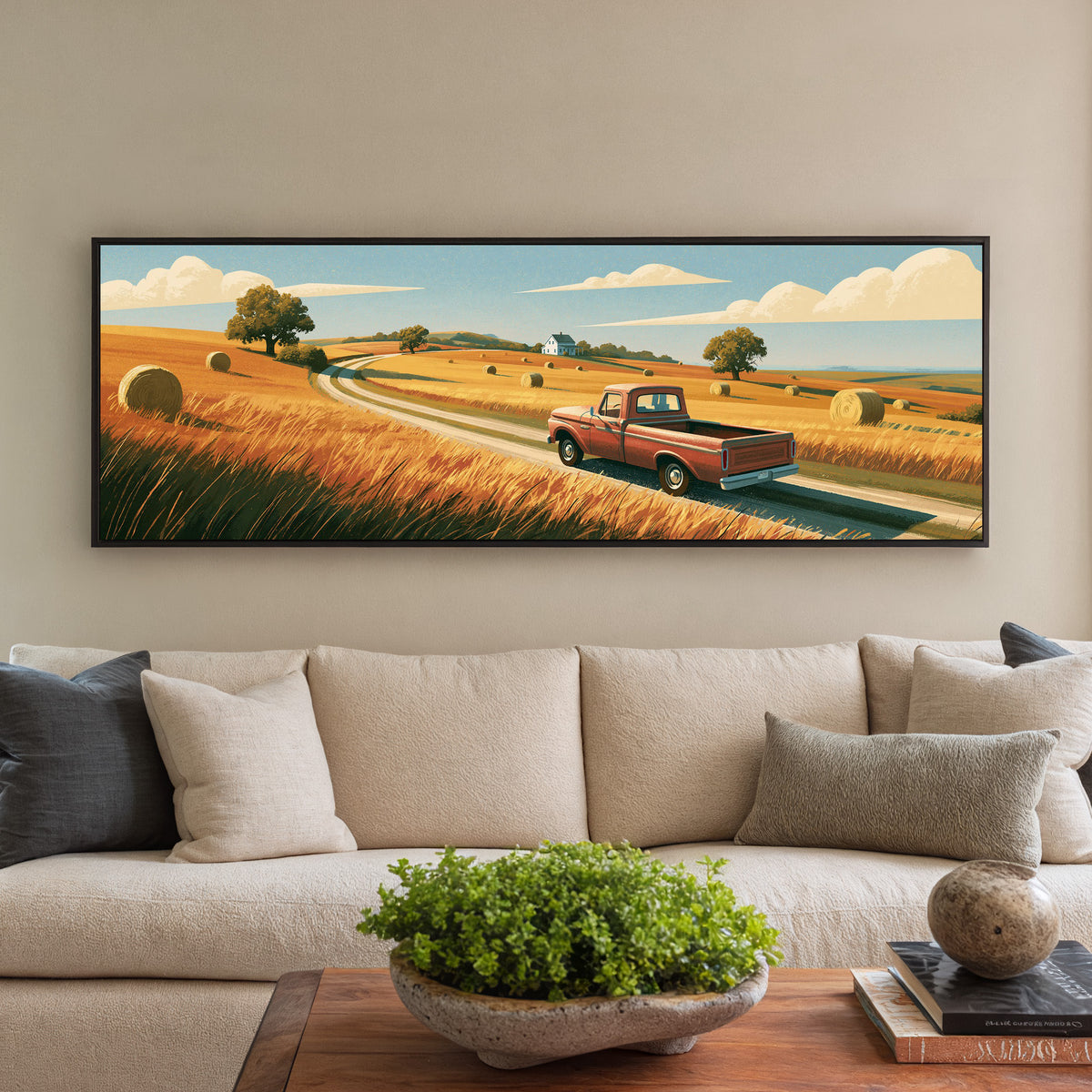 red pickup on a winding road through golden canvas wall art in a black floater frame in a styled room setting