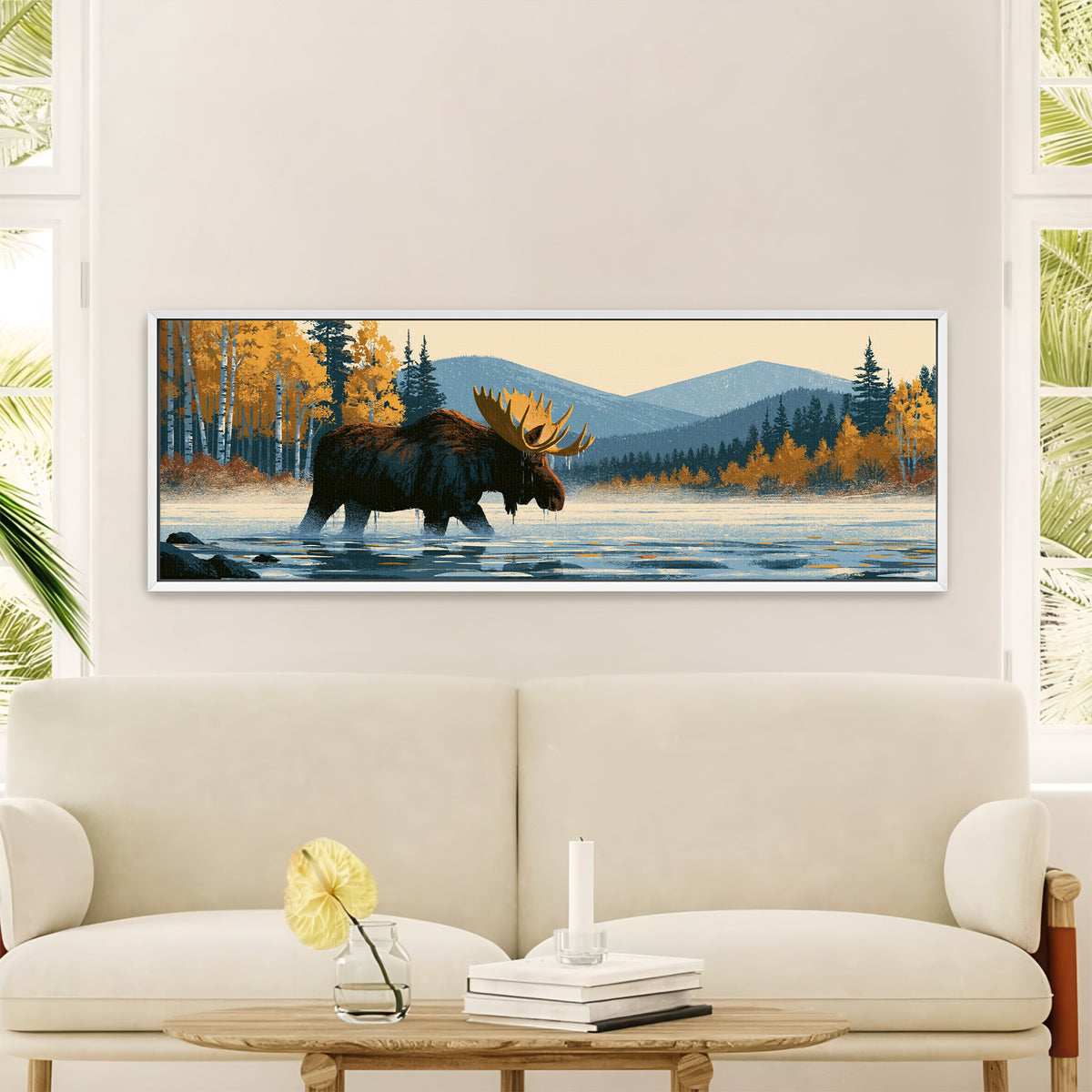 wading moose beneath golden foliage and blue canvas wall art in a white floater frame in a styled room setting