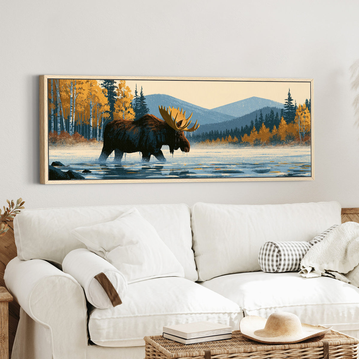 wading moose beneath golden canvas wall art in an oak finish floater frame in a styled room setting