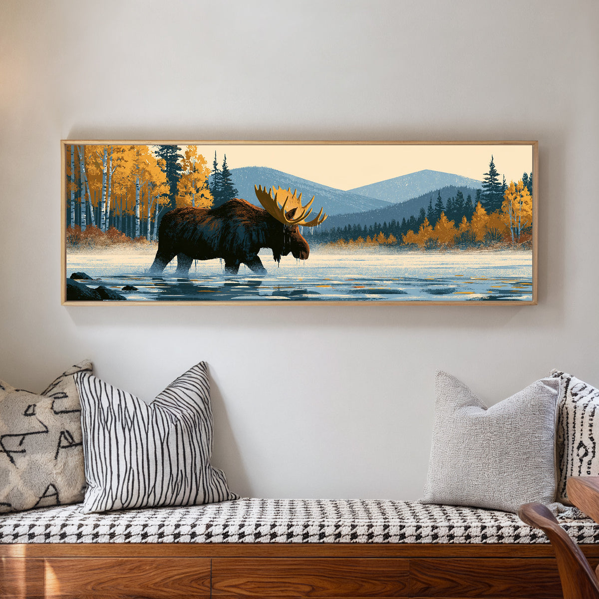 wading moose beneath golden foliage and blue canvas wall art in a natural floater frame in a living room