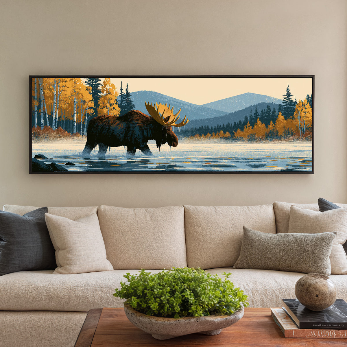 wading moose beneath golden foliage and blue canvas wall art in a black floater frame in a styled room setting