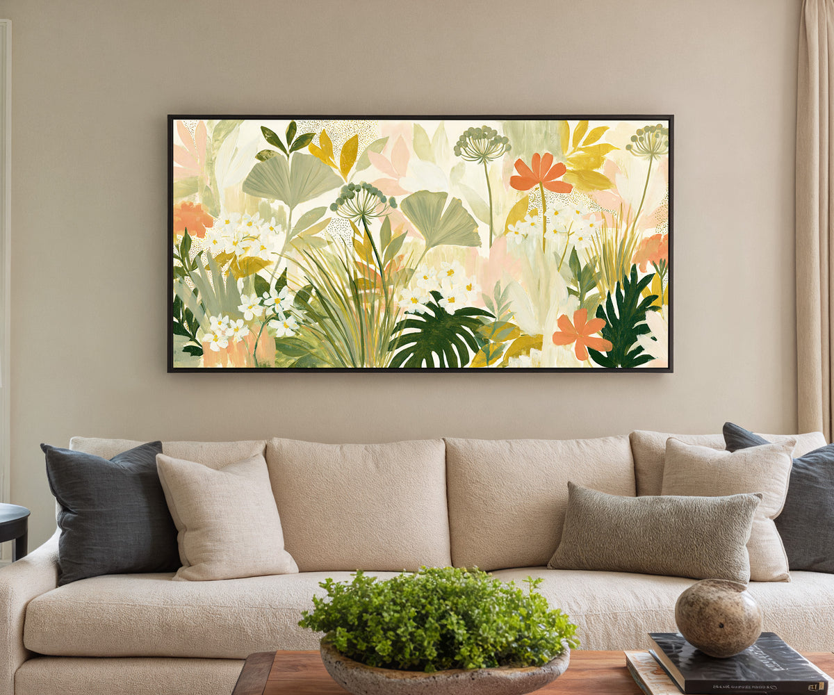 white daisies and coral flowers canvas wall art in a black floater frame in a styled room setting