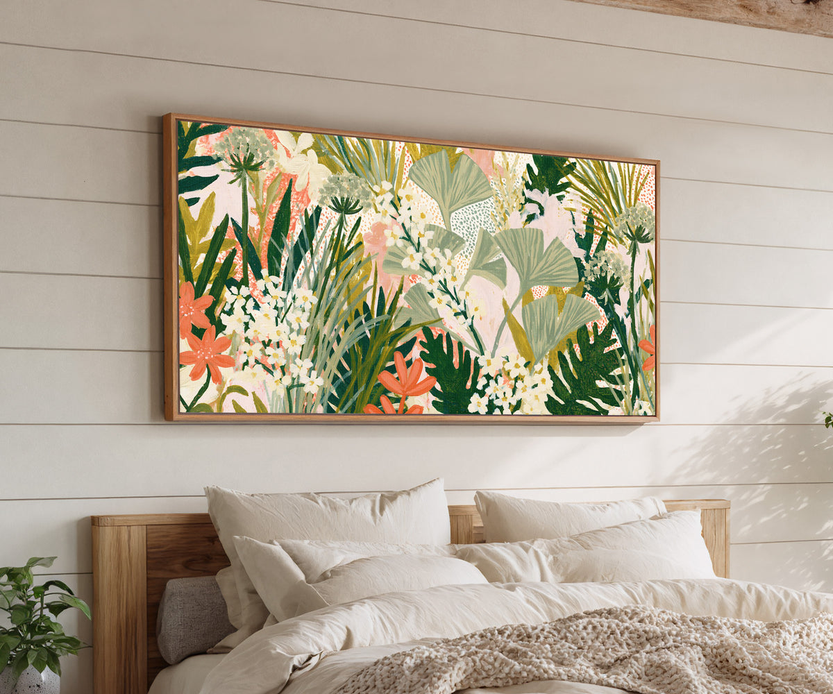 sage fan shaped leaves and white flowers over canvas wall art in an oak finish floater frame above a bed