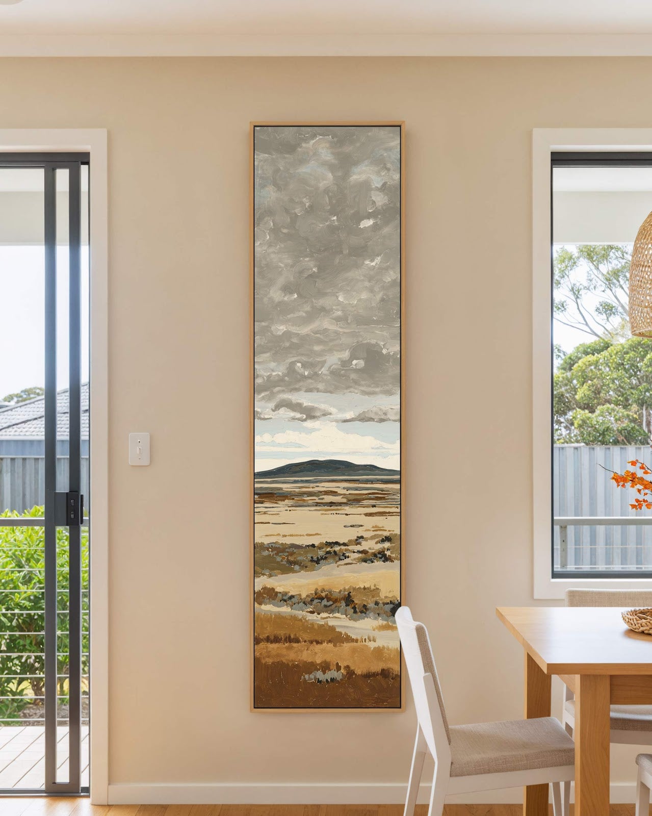 Vertical canvas wall art in interior setting.