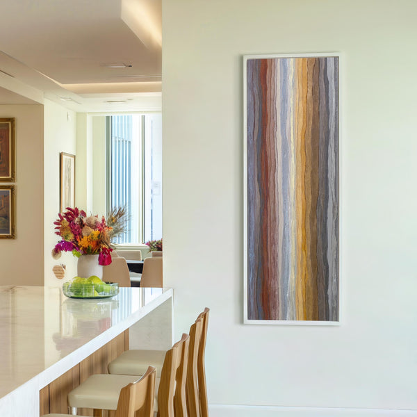 Vertical canvas wall art in interior setting.