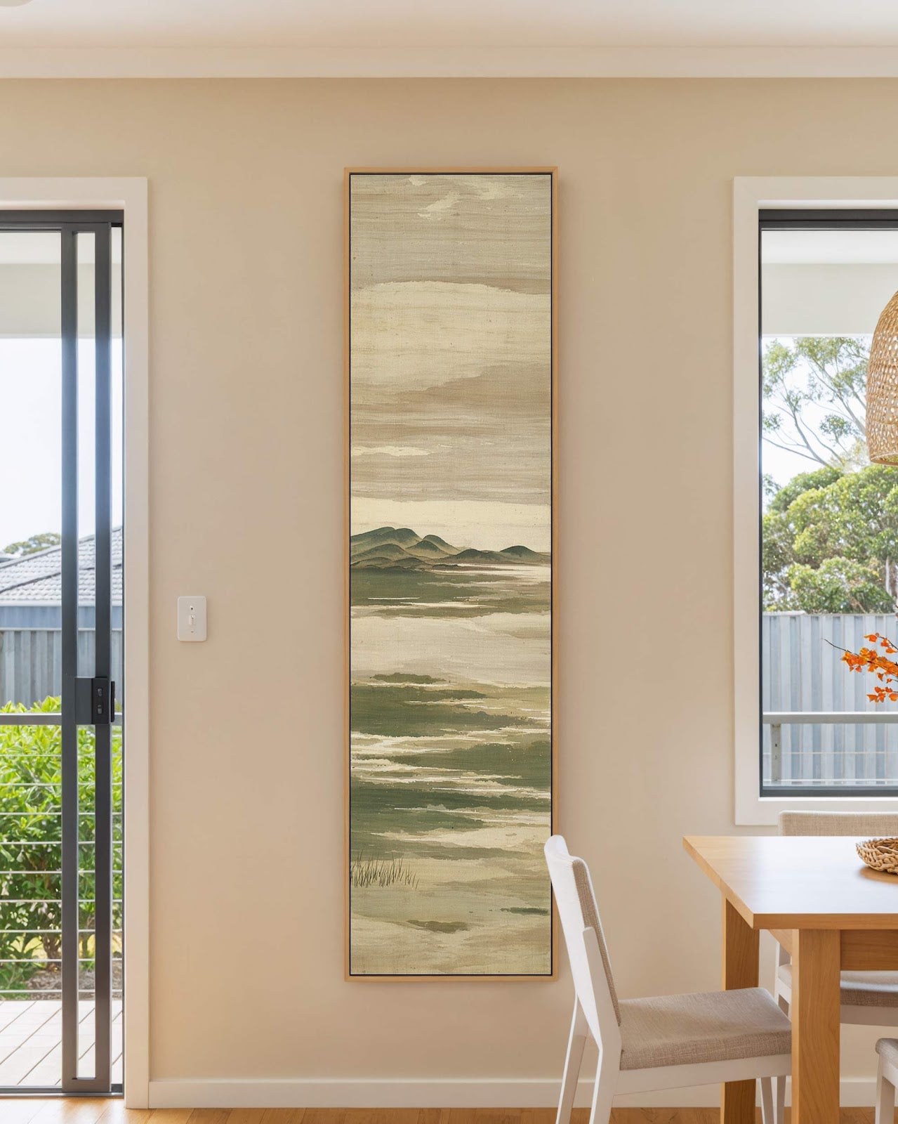 Vertical canvas wall art in interior setting.