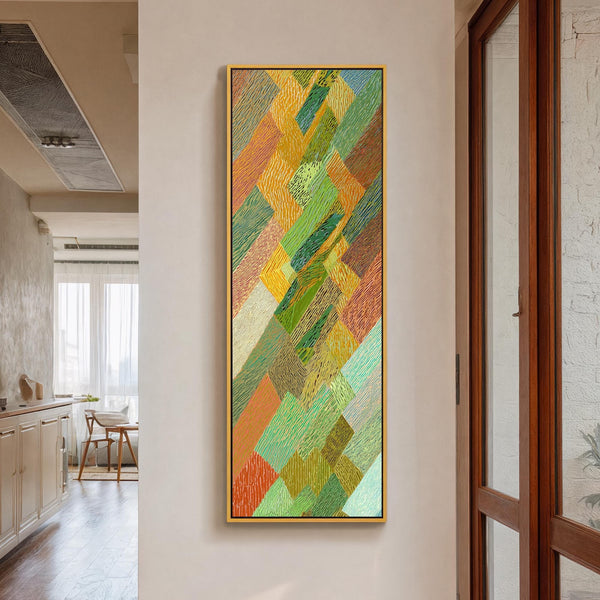 Vertical canvas wall art in interior setting.