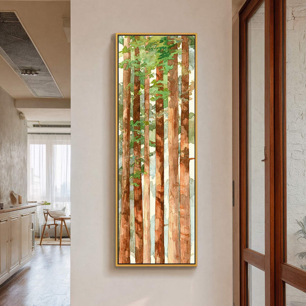 This vertical canvas wall art features a watercolor painting of tall trees with lush green foliage against a soft yellow background, framed in gold with a black inner edge, displayed.