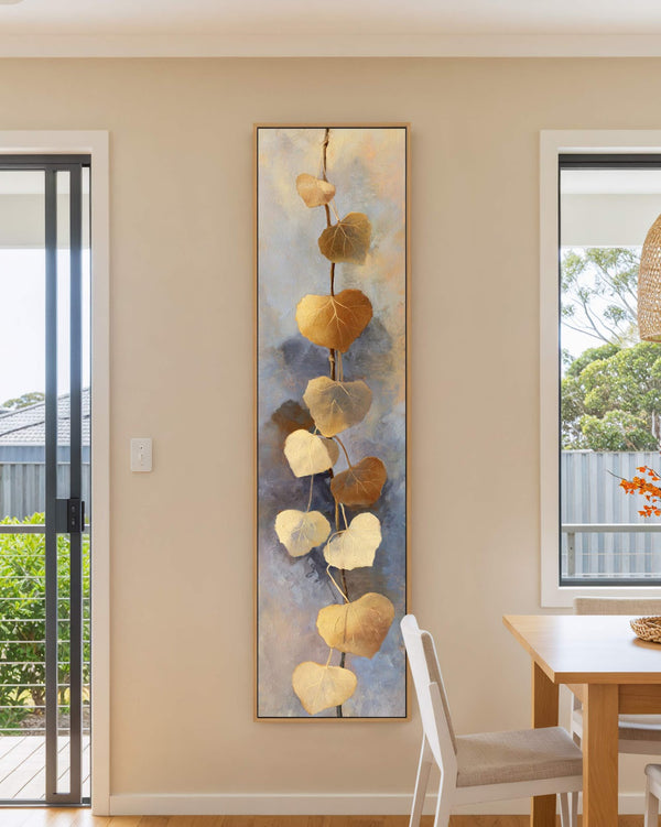 Vertical canvas wall art in interior setting.