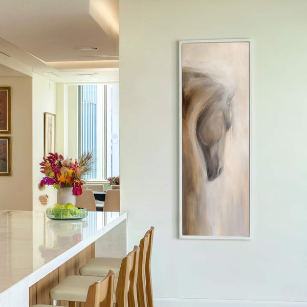 This vertical canvas wall art features a painterly, impressionistic depiction of a horse's head in a neutral palette, framed in white, hanging on a light-colored wall above a console table.