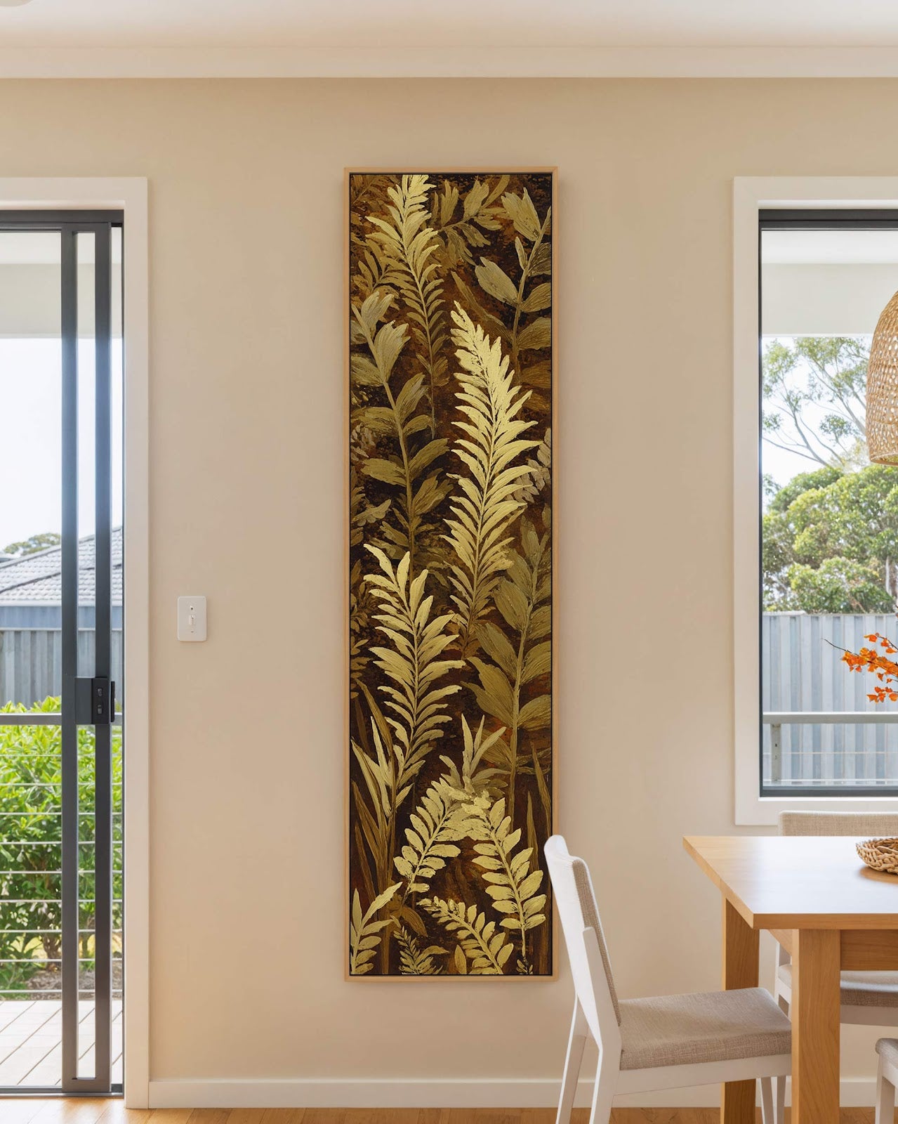 Vertical canvas wall art in interior setting.