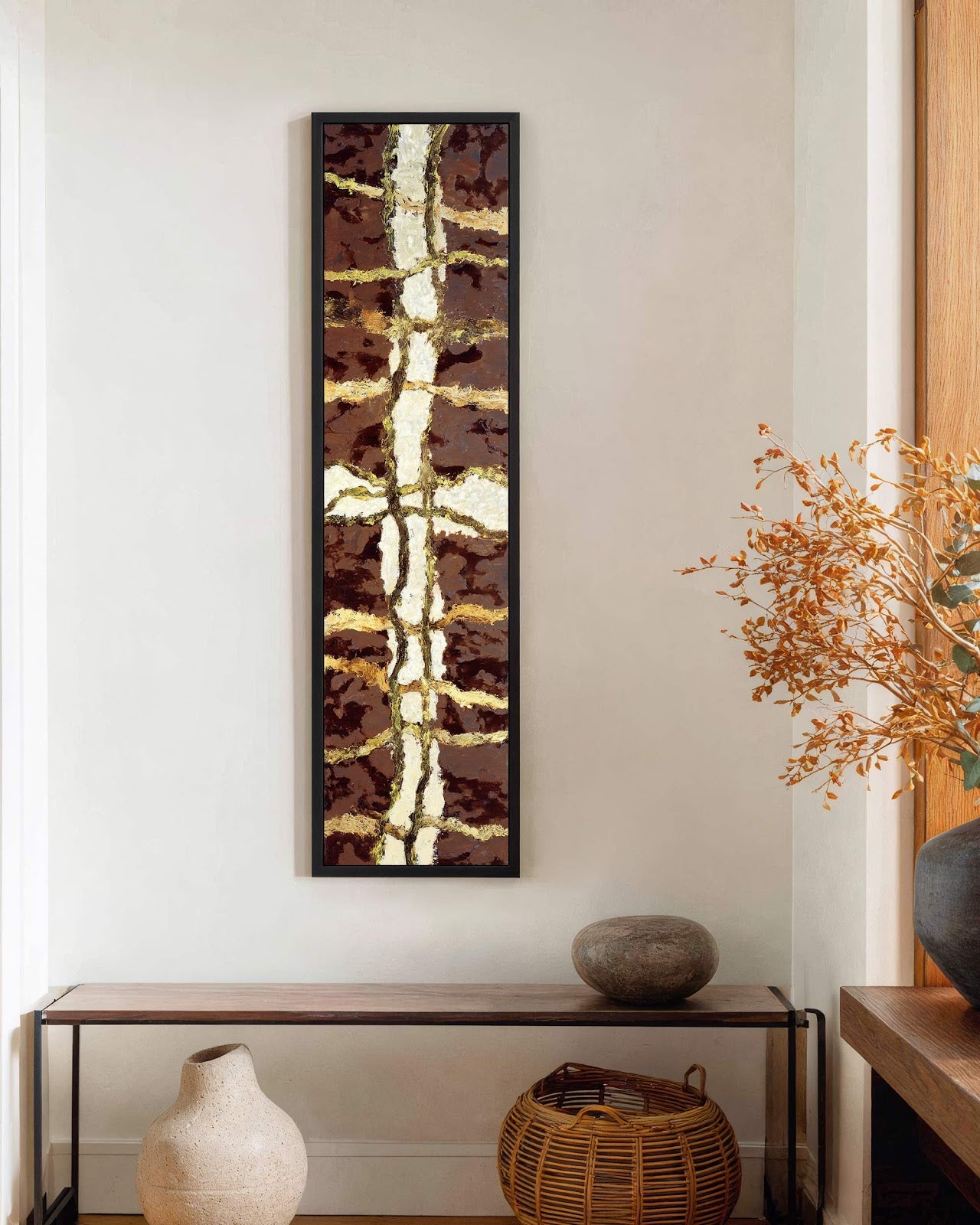 Vertical canvas wall art in interior setting.
