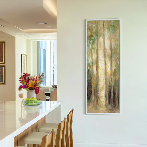 This vertical canvas wall art depicts an impressionistic forest with a palette of greens and yellows, framed in white and hanging on a light-colored wall above what appears to be.
