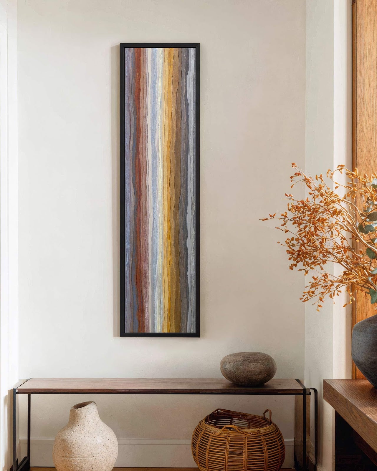 Vertical canvas wall art in interior setting.