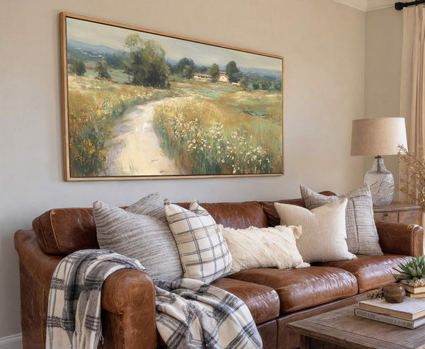 This horizontal, landscape-oriented canvas wall art depicts a pastoral scene with a dirt path winding through a field of wildflowers, rendered in a soft, impressionistic style with a warm, earthy.