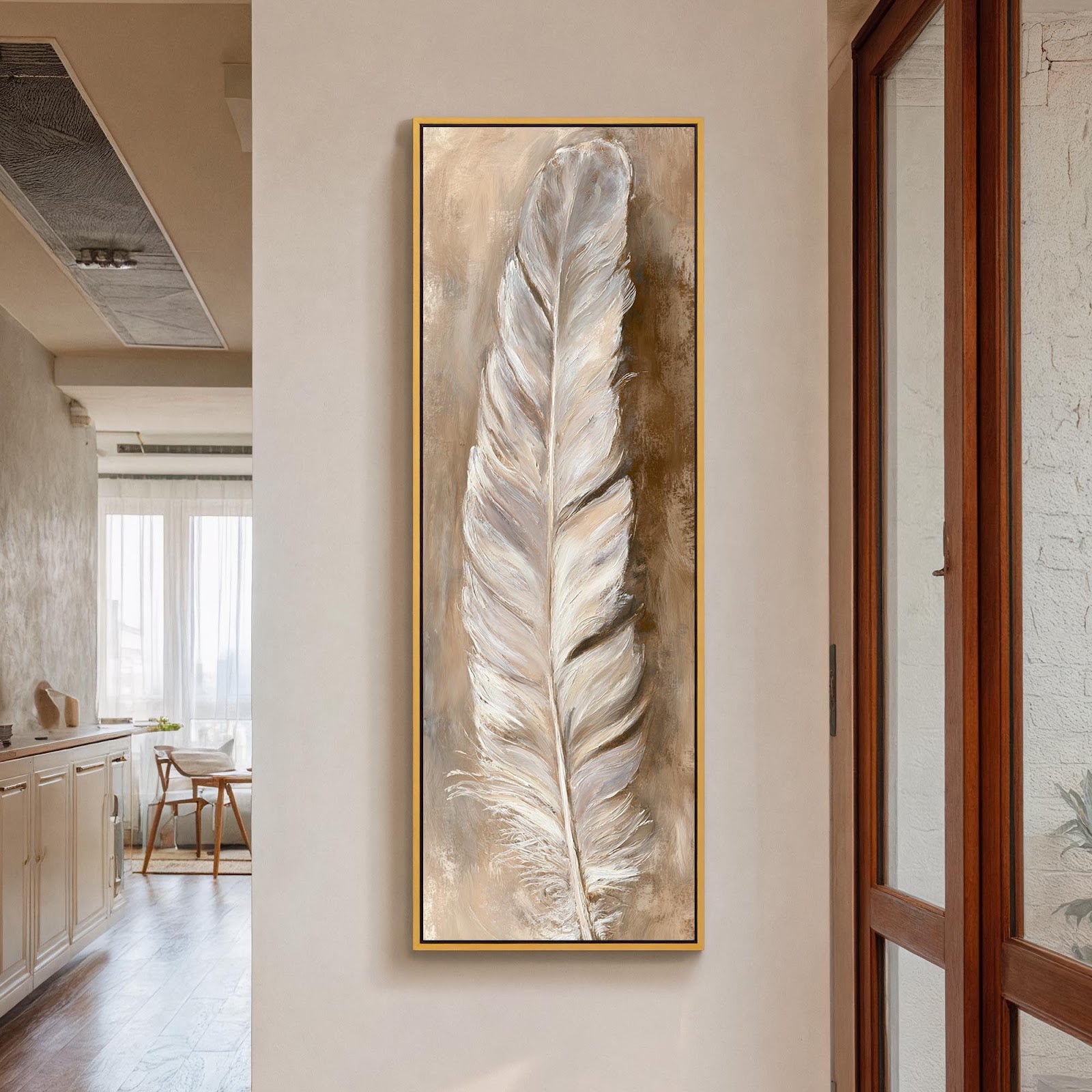 This vertical canvas wall art showcases a textured white feather in earthy neutral tones, displayed in a gold floater frame on a white hallway wall beside a glass door.