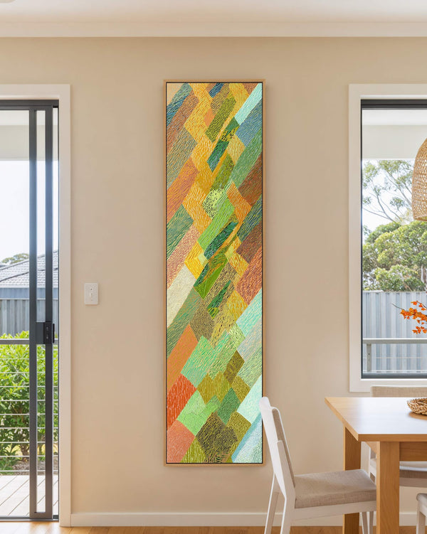 Vertical canvas wall art in interior setting.