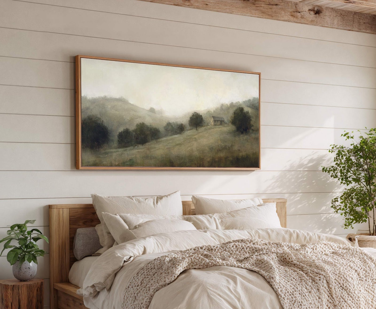 This horizontal canvas wall art features a misty landscape with a small cabin, rendered in muted earth tones and a soft, impressionistic style, displayed above a bed with plush bedding.