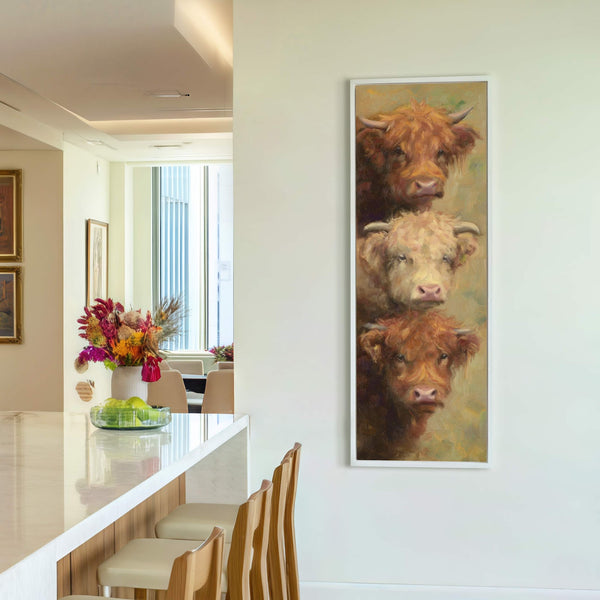 This vertical canvas print features a painterly style with a palette of earthy tones depicting three Highland cows stacked vertically against a light-colored wall. The artwork is framed in white.