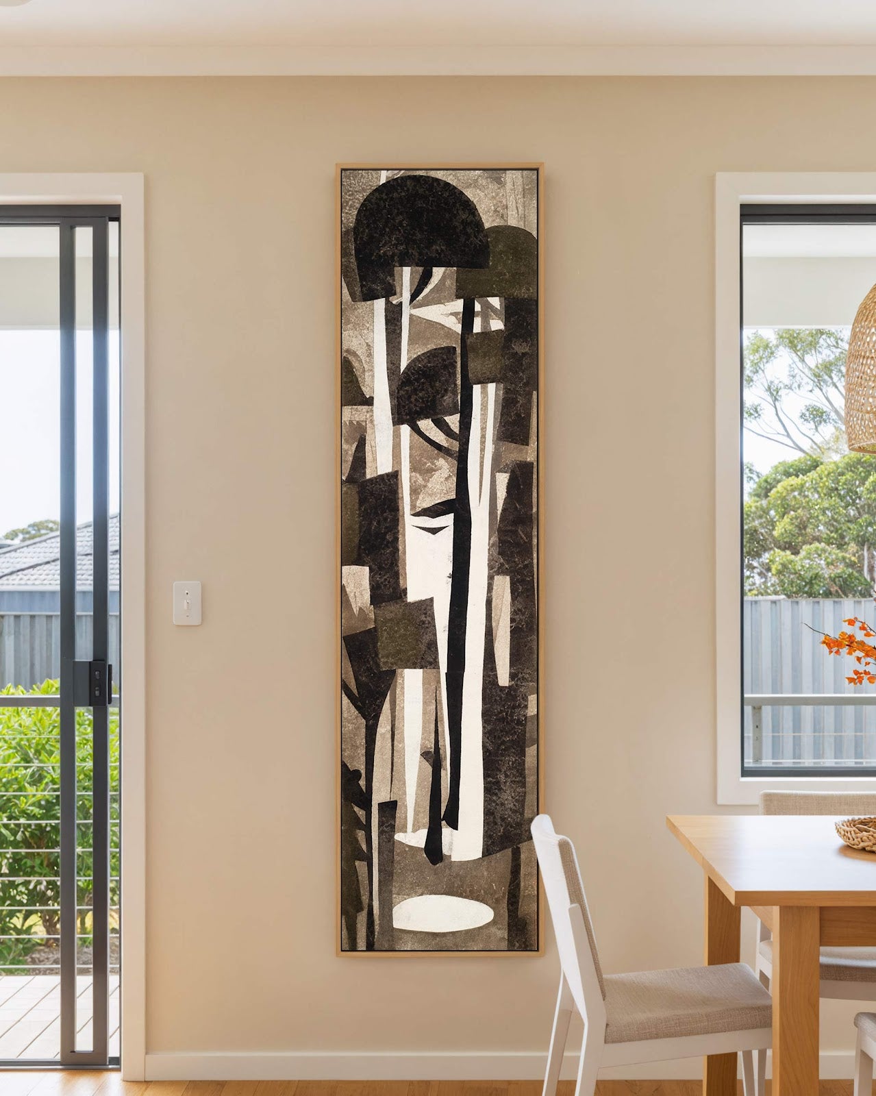 Vertical canvas wall art in interior setting.
