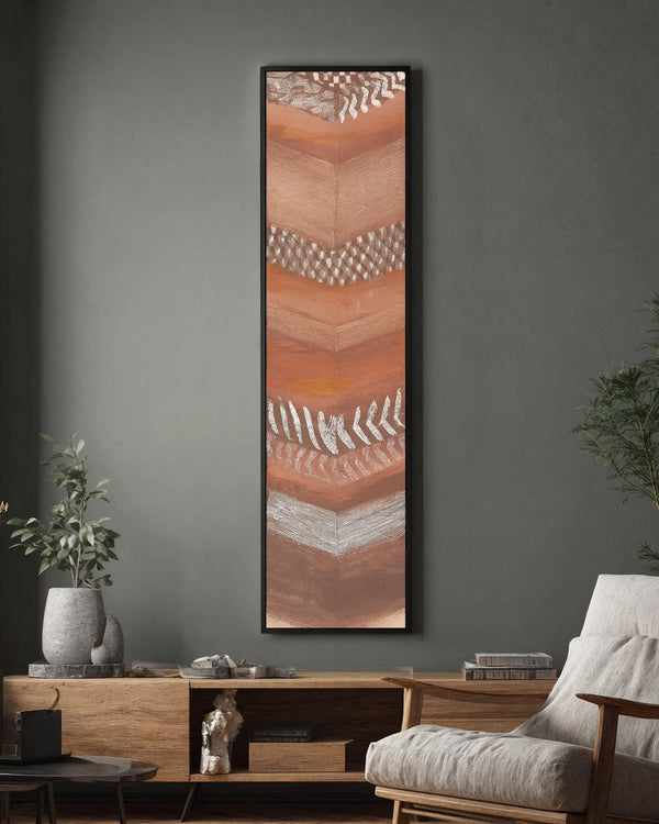 Vertical canvas wall art in interior setting.