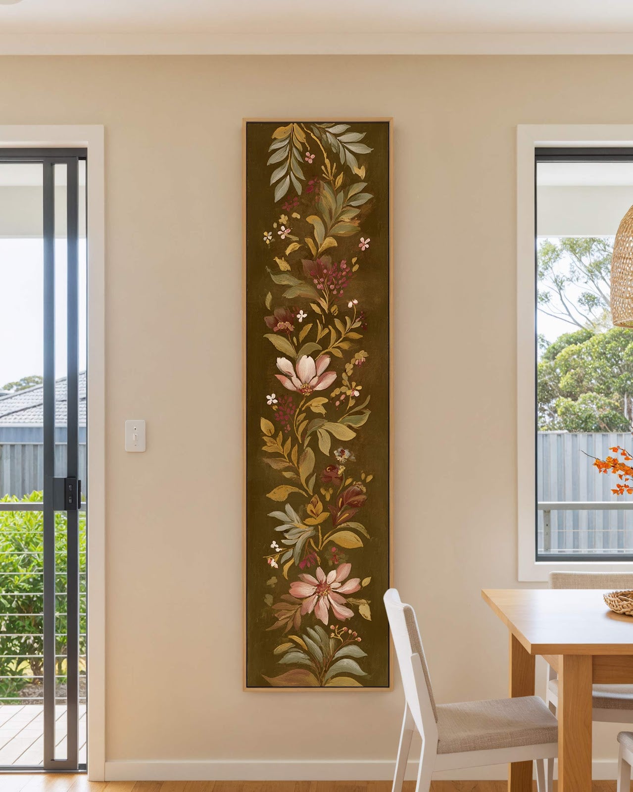 Vertical canvas wall art in interior setting.