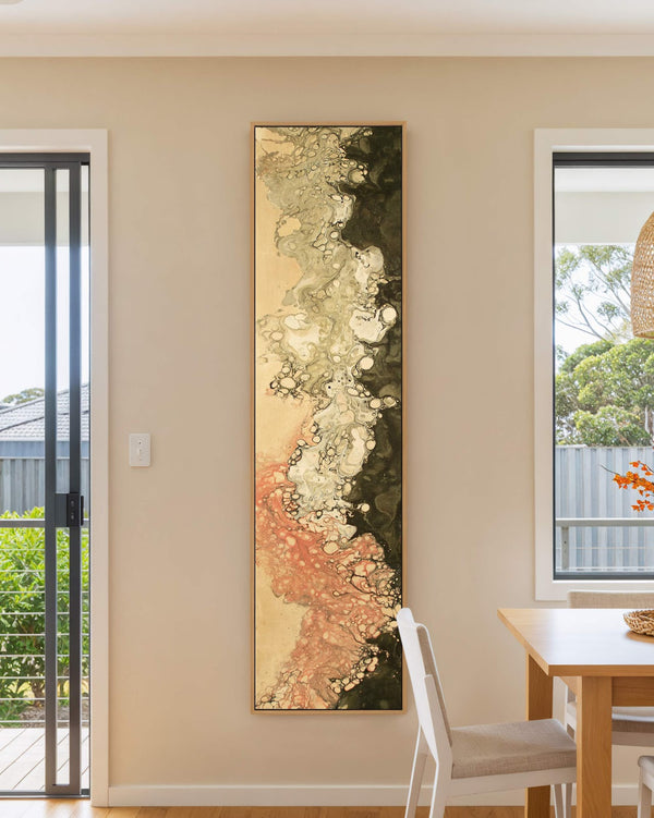 Vertical canvas wall art in interior setting.