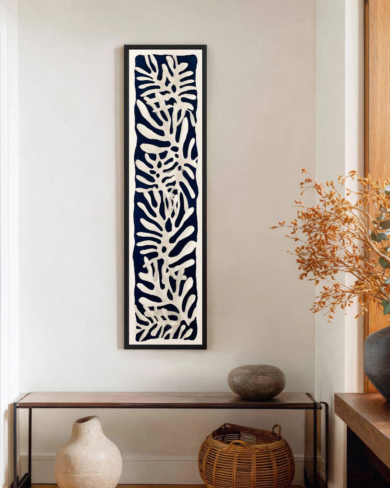 Vertical canvas wall art in interior setting.