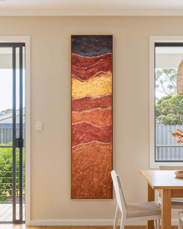 Vertical canvas wall art in interior setting.