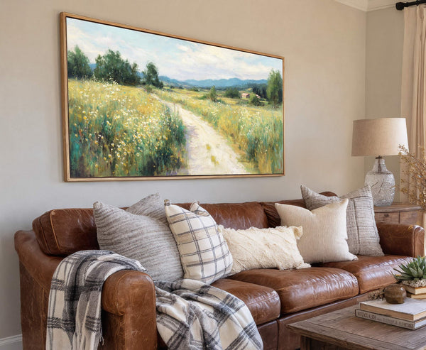 This horizontal canvas wall art depicts a pastoral landscape with a dirt path winding through a field of wildflowers and trees under a blue sky. The impressionistic style and vibrant.