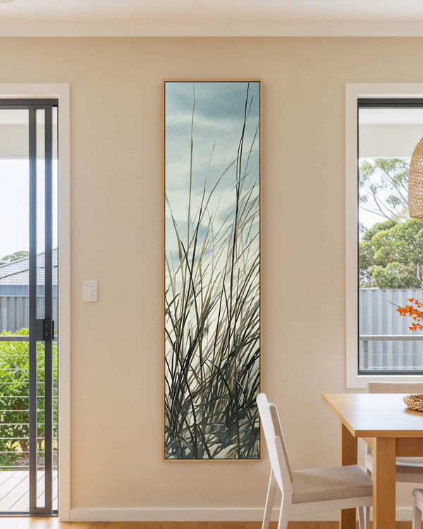 Vertical canvas wall art in interior setting.