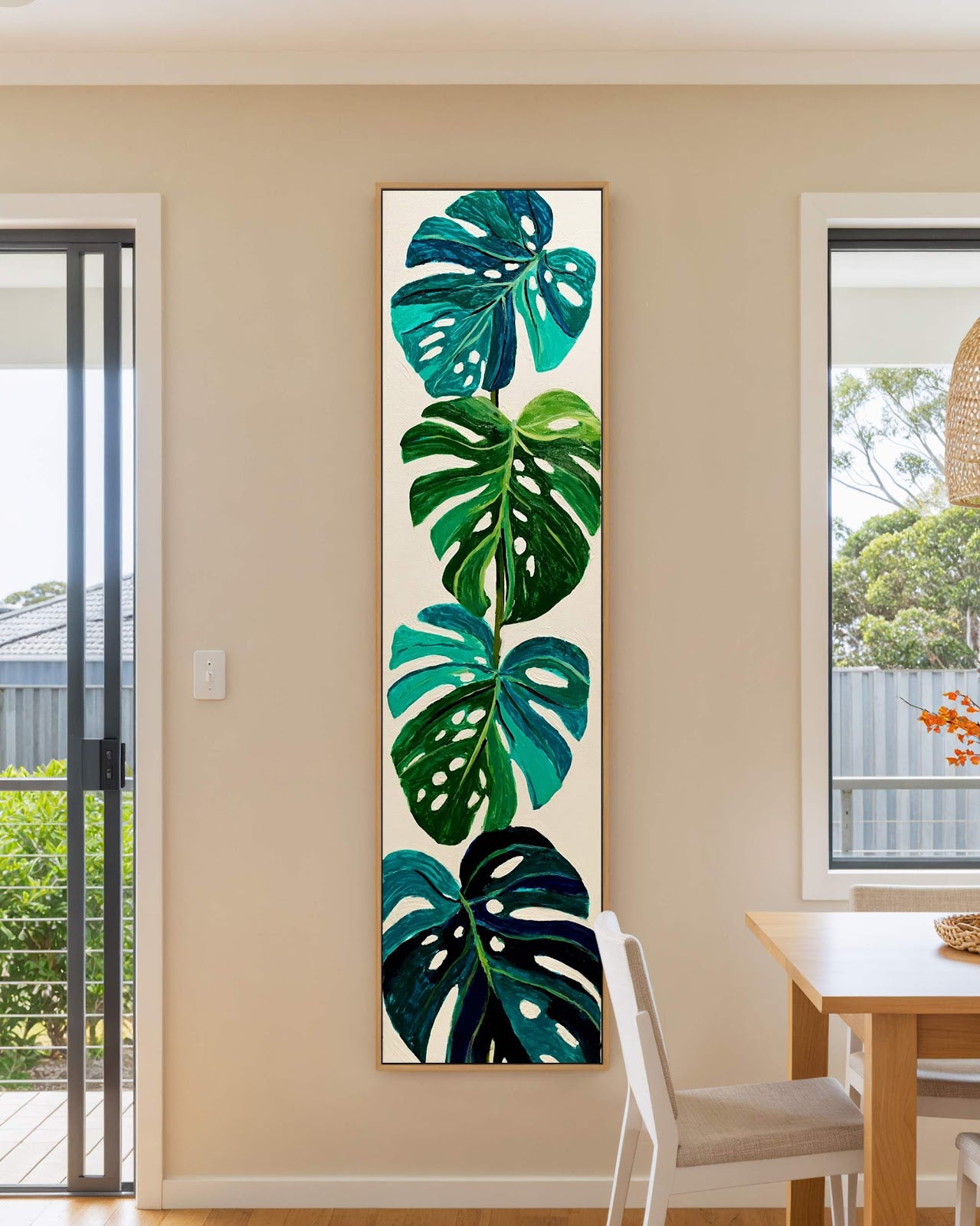 Vertical canvas wall art in interior setting.