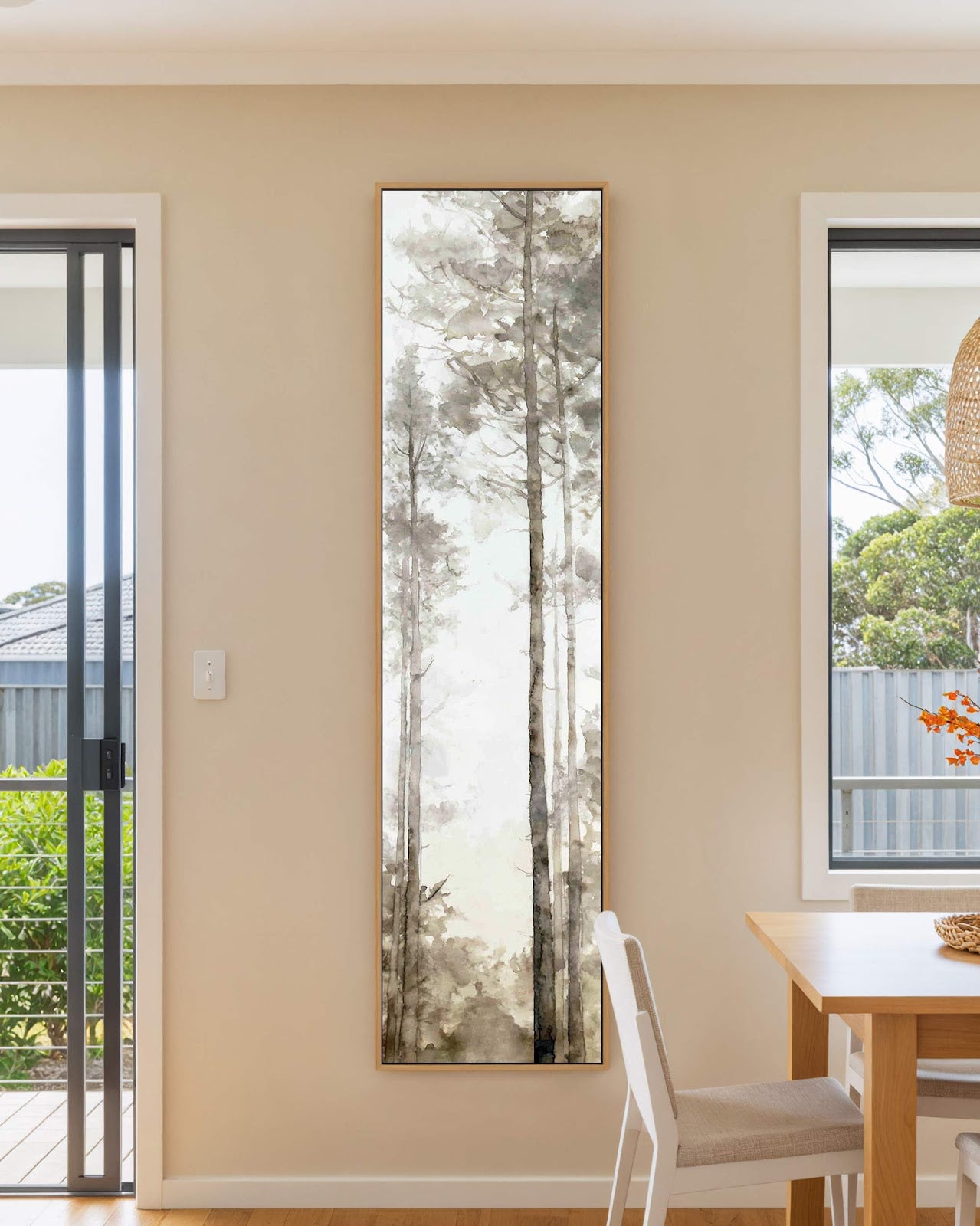 Vertical canvas wall art in interior setting.