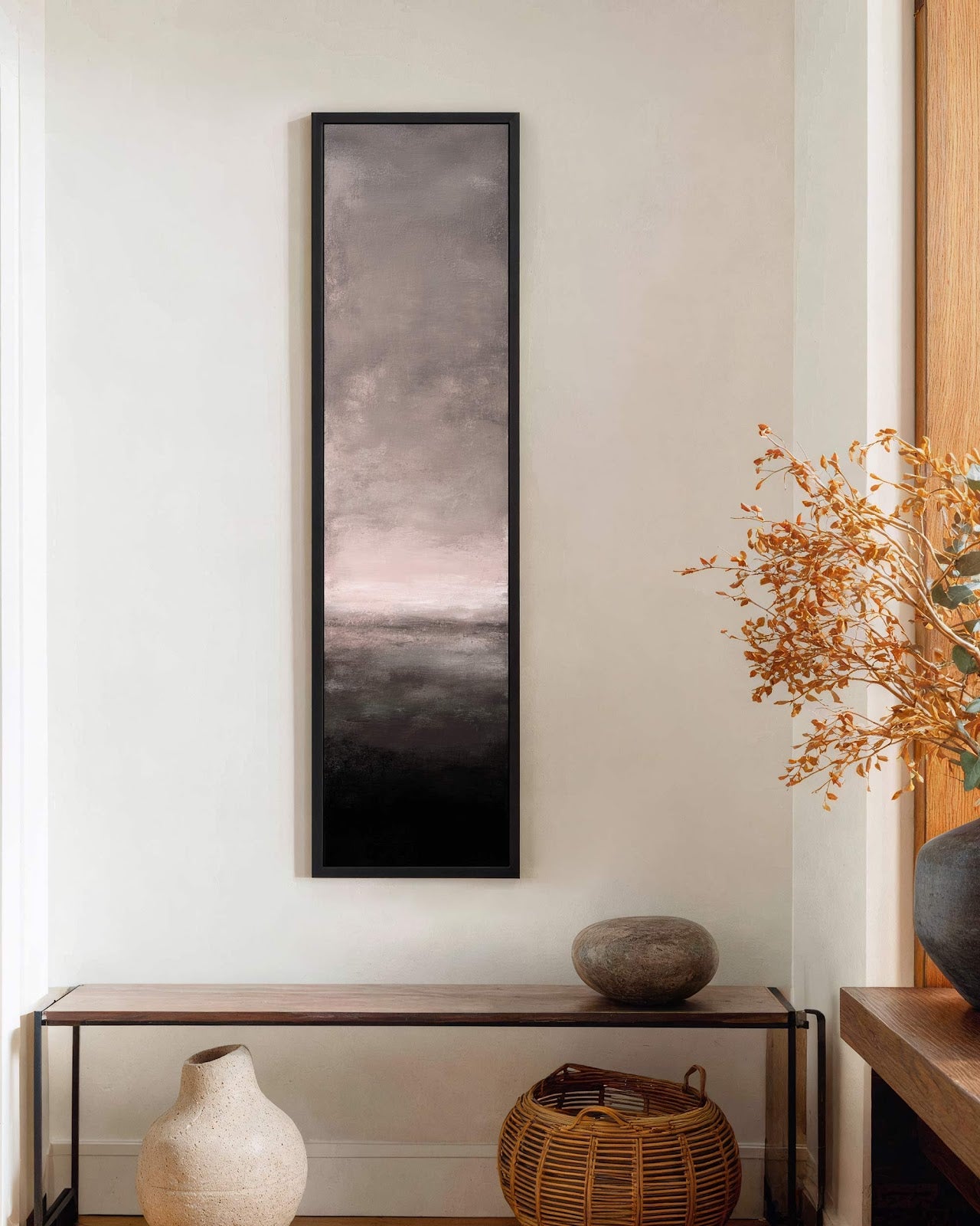 Vertical canvas wall art in interior setting.