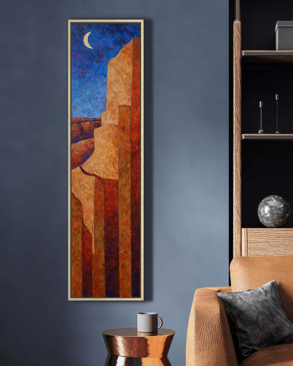 Vertical canvas wall art in interior setting.