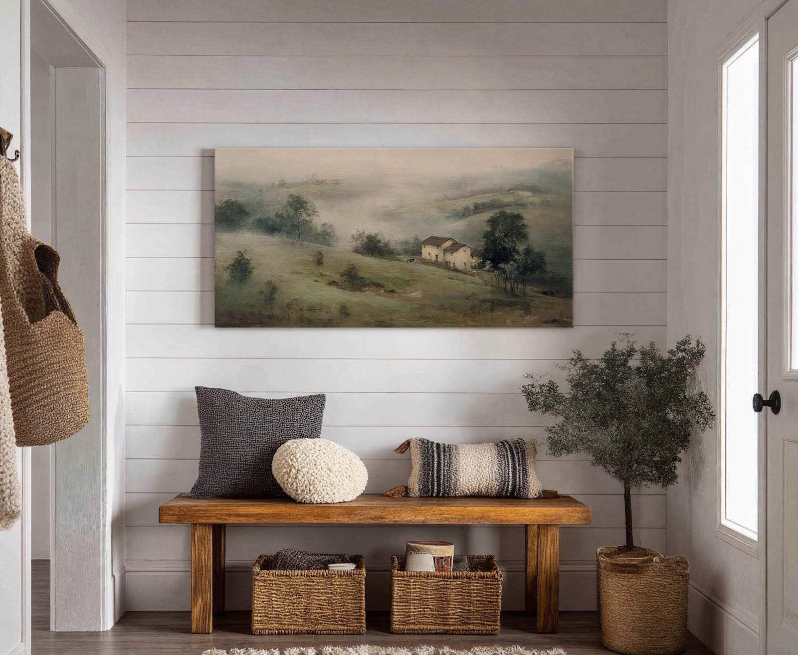 This horizontal canvas wall art features a hazy, impressionistic landscape with rolling hills and a small village, rendered in muted greens and earthy tones. It is displayed on a white.