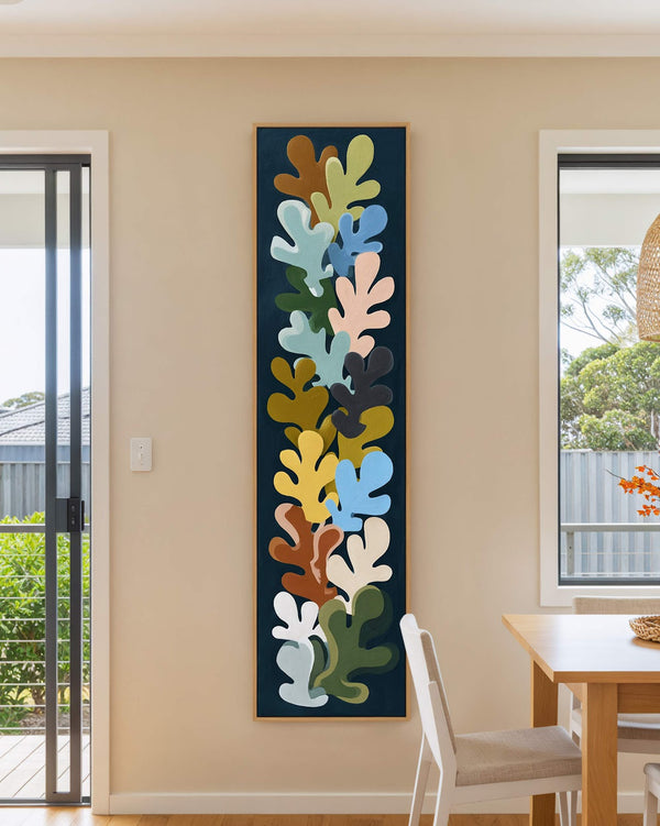 Vertical canvas wall art in interior setting.