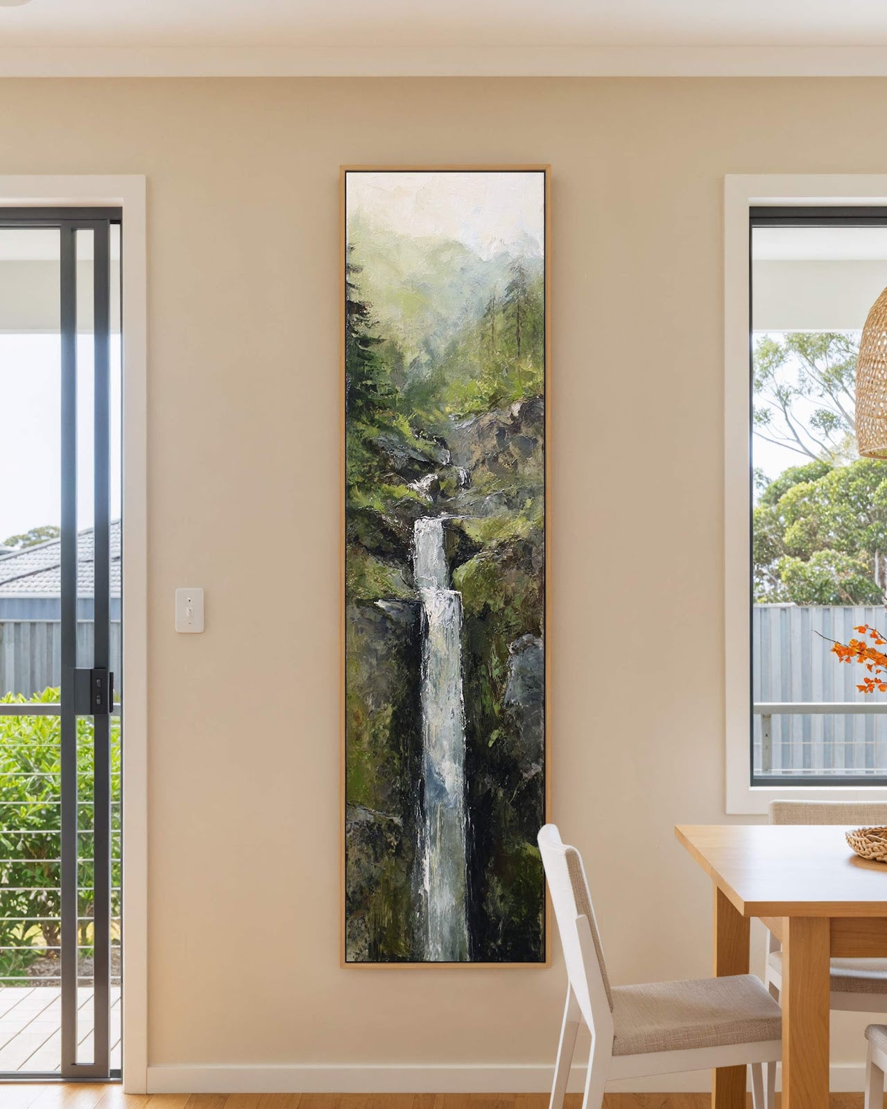 Vertical canvas wall art in interior setting.