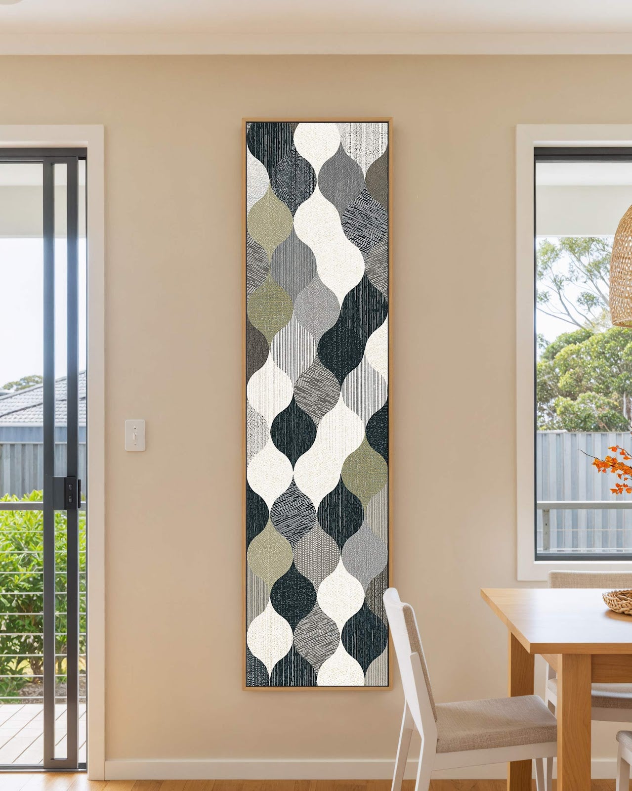 Vertical canvas wall art in interior setting.