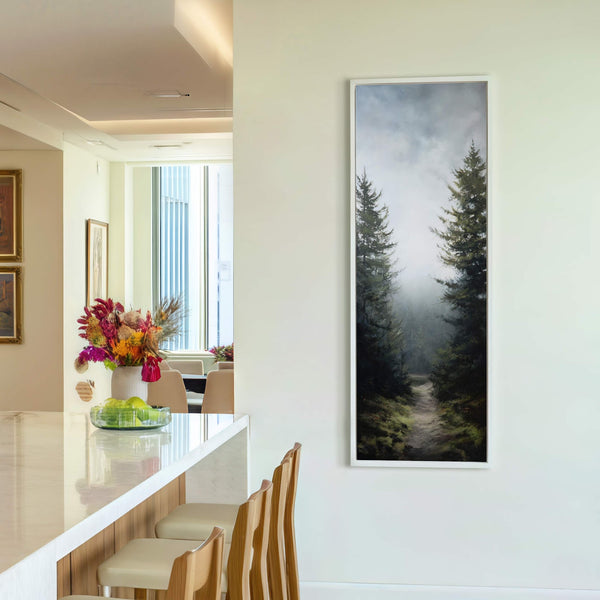 This vertical canvas print displays a moody forest scene with dark green trees and a foggy path. The art print is framed in white and hangs on a light-colored wall.