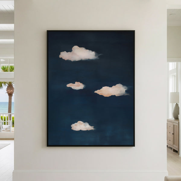 Abstract wall art featuring four soft peachy-white clouds floating on a deep midnight blue background, creating a serene minimalist cloudscape perfect for modern home decor