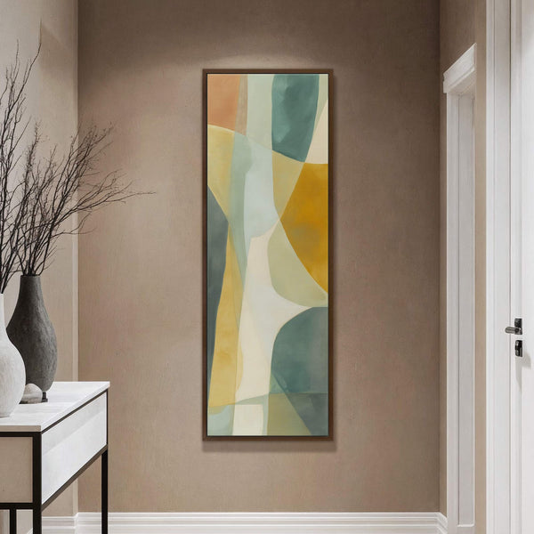 This vertical canvas wall art features an abstract subject with a palette of teal, yellow, and orange hues, framed in dark wood and hung on a taupe wall in a.