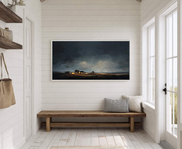 This horizontal canvas wall art features a dramatic landscape with a dark, cloudy sky over a rural scene with illuminated buildings, presented in a realistic style with a muted palette.