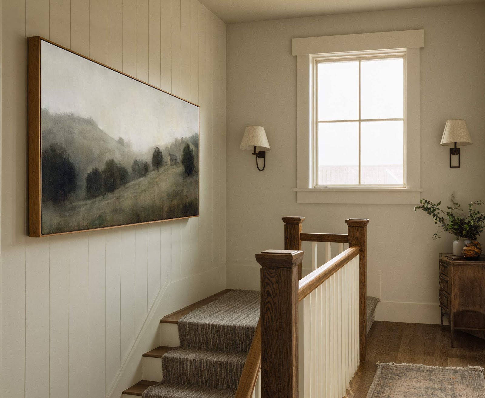 This horizontal canvas wall art depicts a hazy, pastoral landscape with trees and a small building, rendered in a muted, atmospheric palette and style. It is displayed on a paneled.