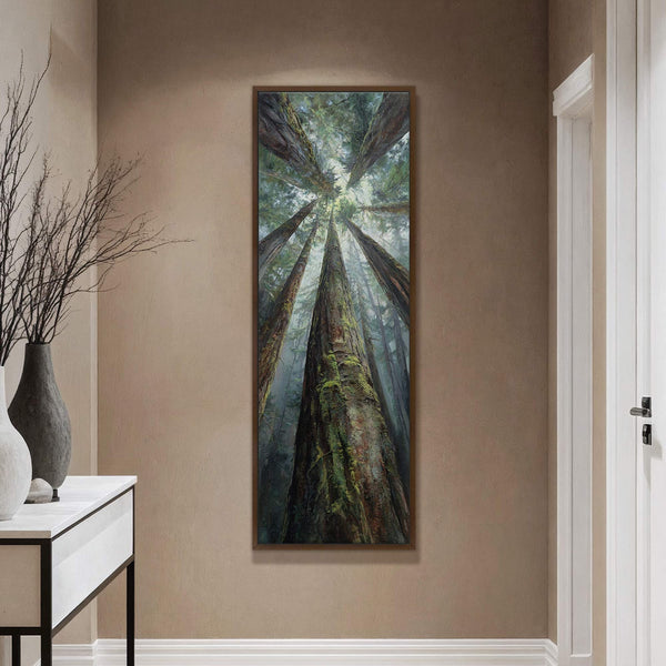 This vertical art print depicts a realistic, impressionistic view looking up through tall trees in a foggy forest, with a rich green and brown palette, displayed on a textured taupe.