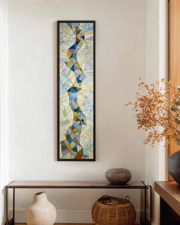 Vertical canvas wall art in interior setting.