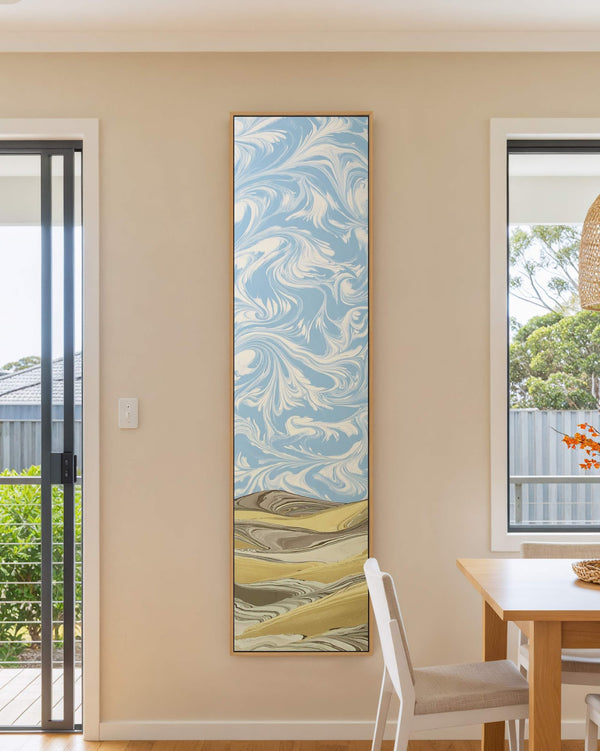 Vertical canvas wall art in interior setting.